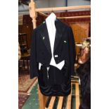 An early 20th century gentleman's evening tails, waistcoat and trousers