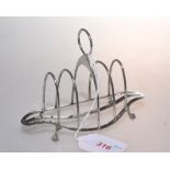 An Edwardian silver four division toast rack on ball and claw feet, Birmingham 1909, 2.2 troy