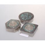 A group of three Mexican silver pill boxes each with South American designs to the covers and