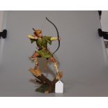 A Royal Doulton figure of Robin Hood standing on a branch with his bow and arrow