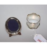 A silver napkin ring tog. with a silver photograph frame (2)