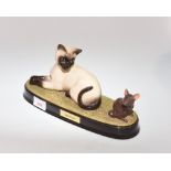 A Beswick china figure of a Siamese cat with a mouse, titled on the oval plinth "Watch It"