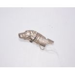 A silver dog whistle in the form of a spaniel, marked London 1962, 1.4 troy ounces