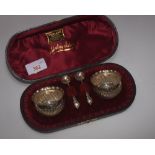 A cased pair of Silver salts and spoons, Birmingham 1876, maker's mark for T.W. of circular form