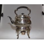 An Edwardian silver plate teapot on stand with burner, the gadrooned body raised on a stand