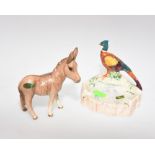 A Beswick china figure of a donkey together with a Beswick china ashtray with a  pheasant, both with