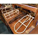 A group of four painted metal saddle racks