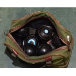 A canvas bag containing a large quantity of lawn bowls inc. Thomas Taylor