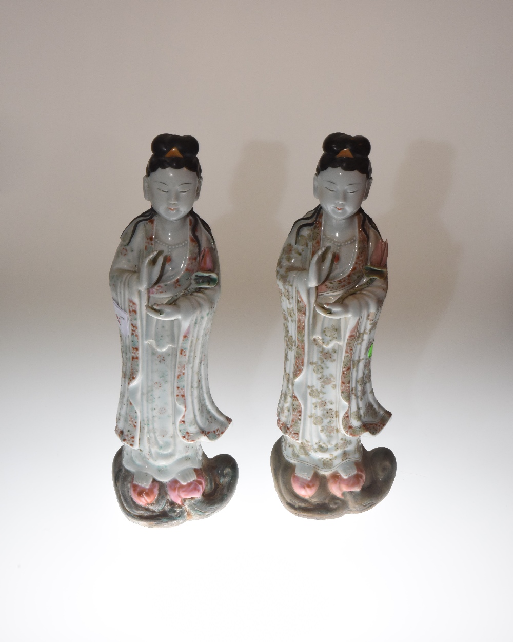 A pair of Chinese stoneware Guan Yin figures, each with impressed four character mark to base.