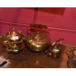 A group of three copper and brass kettles