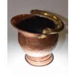 A 19th century brass and copper coal scuttle