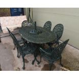 A late 19th century painted wrought iron garden table; tog. with six chairs inc. two carvers and a