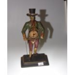 A reproduction painted metal clock figure