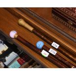 A group of three walking sticks, two with golf ball handles