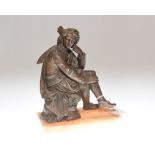 A late 19th century spelter figure of a Renaissance youth, modelled seated on a capital, on an