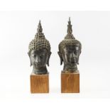 TWO SOUTH-EAST ASIAN BRONZE HEADS OF BUDDHA, probably 19th century, both with knotted hair, one with