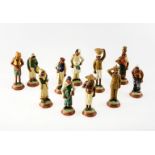 A GROUP OF ELEVEN INDIAN CLAY FIGURES, hand painted and modelled in various traditional costumes, in