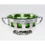 A LIBERTY & Co. PEWTER TWIN-HANDLED BOWL WITH GREEN GLASS LINER, possibly by David Veasey or