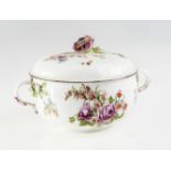 A CHELSEA PORCELAIN ECUELLE AND COVER, c.1760, painted with floral sprays, the twig handles