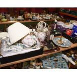 A tray inc. an Indian figural stand, three pottery table lamps, a quantity of linens, a cranberry