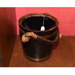 A brass bound wooden pail with a rope and leather handle. Height 31cm