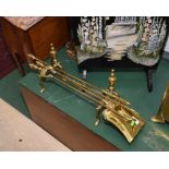 An early 20th century brass fireside companion set