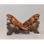 A pair of carved wooden tigers.