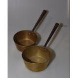 A pair of brass saucepans