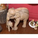 A carved wood Asian elephant and her young, 36cm high