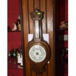 An oak cased anoroid barometer