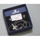 A Swarovski cross pendant with earrings en suite