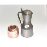 A 19th century pewter lidded flagon; together with a copper ring mould of similar date. (2)
