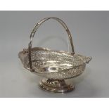 An Edwardian silver swing-handled cake basket, Walker & Hall, Sheffield 1907, of oval form,