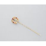 An Edwardian 9ct gold horseshoe stick pin, set with alternating rubies and diamonds, cased.