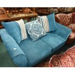 A two seater sofa in teal