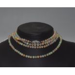 A long single strand opal bead necklace, on a diamond-set clasp. Length approx. 1.40 metres