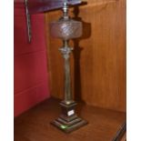 A 19th century brass Corinthian column oil lamp with clear glass reservoir converted to a table