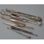 A group of Victorian silver mounted button hooks and glove stretchers (9)
