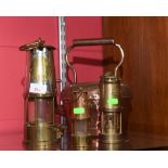 Three brass, copper, and white metal miners lamps of varying sizes tog. with a copper kettle. (4)
