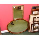 An early 20th century oval satinwood crossbanded mirror; together with a modern gilt mirror (2)