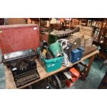 A painted tin cabinet; tog. with a vintage typewriter, a large quantity of vintage oil cans, a crate