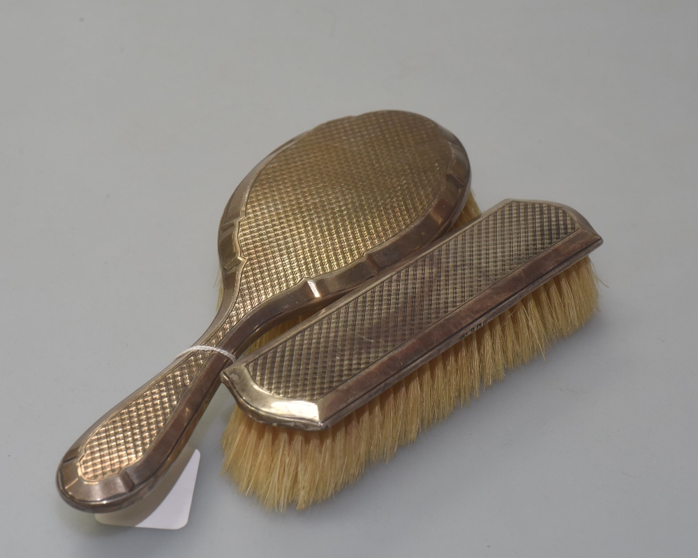 Two silver backed dressing table brushes, both marked for Birmingham