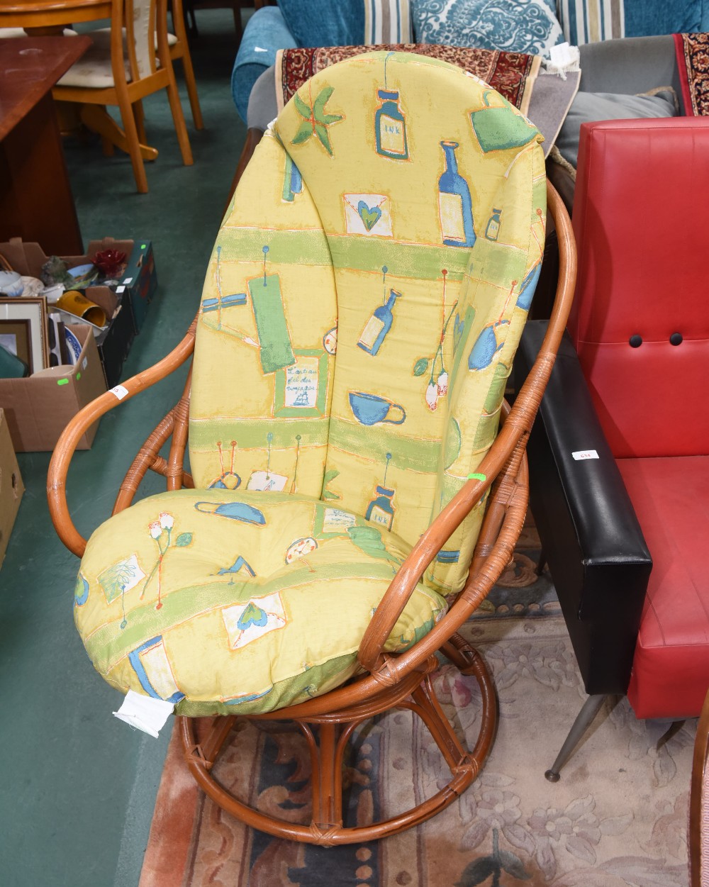 A revolving bamboo framed conservatory chair