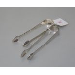 Two pairs of George III Newcastle silver sugar tongs, one pair 1794 with bright-cut decoration,