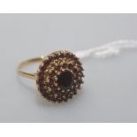 A garnet cluster ring, mounted in 9ct yellow gold. Ring size Q