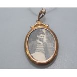 A 9ct gold photograph locket, double sided, of oval form, glazed.