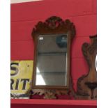 A George III style mahogany fretwork mirror surmounted by a gilt ho ho bird