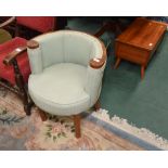 A mid 19th century walnut framed scroll back tub chair