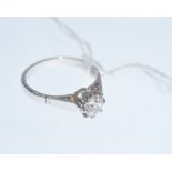 A single stone diamond ring, the round brilliant-cut stone weighing approx. 0.80 carats claw-set