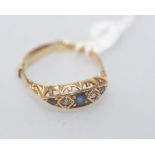 An 18ct gold sapphire and diamond ring, set with three graduated round-cut sapphires spaced by a